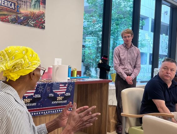 Neil listening to a constituent at a community center