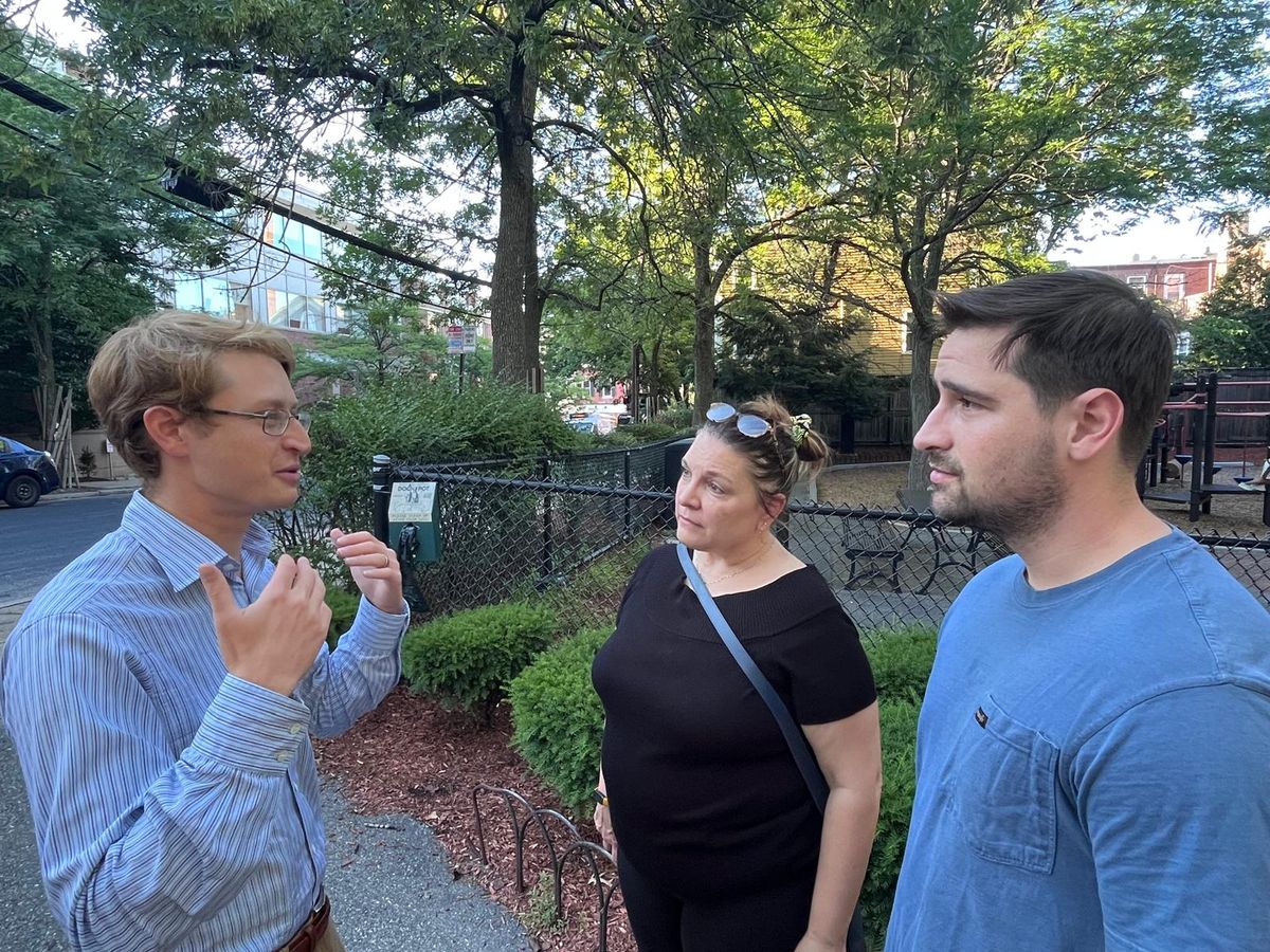 Neil talking with neighbors at a park