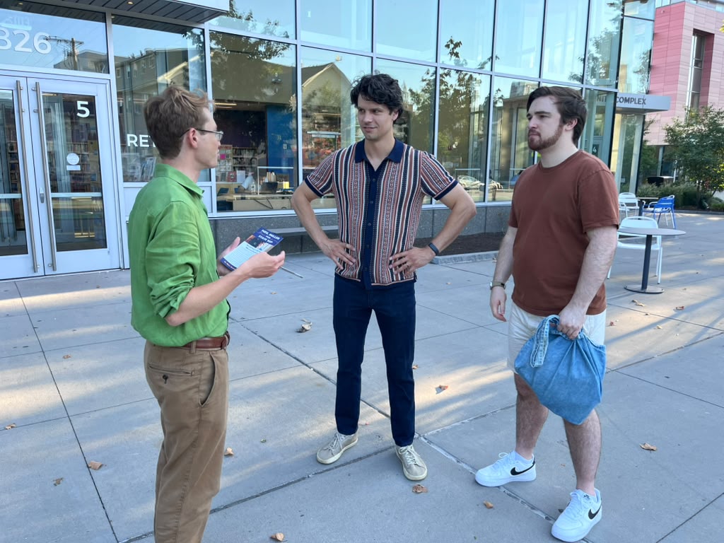 Neil Miller talking with two voters while canvassing