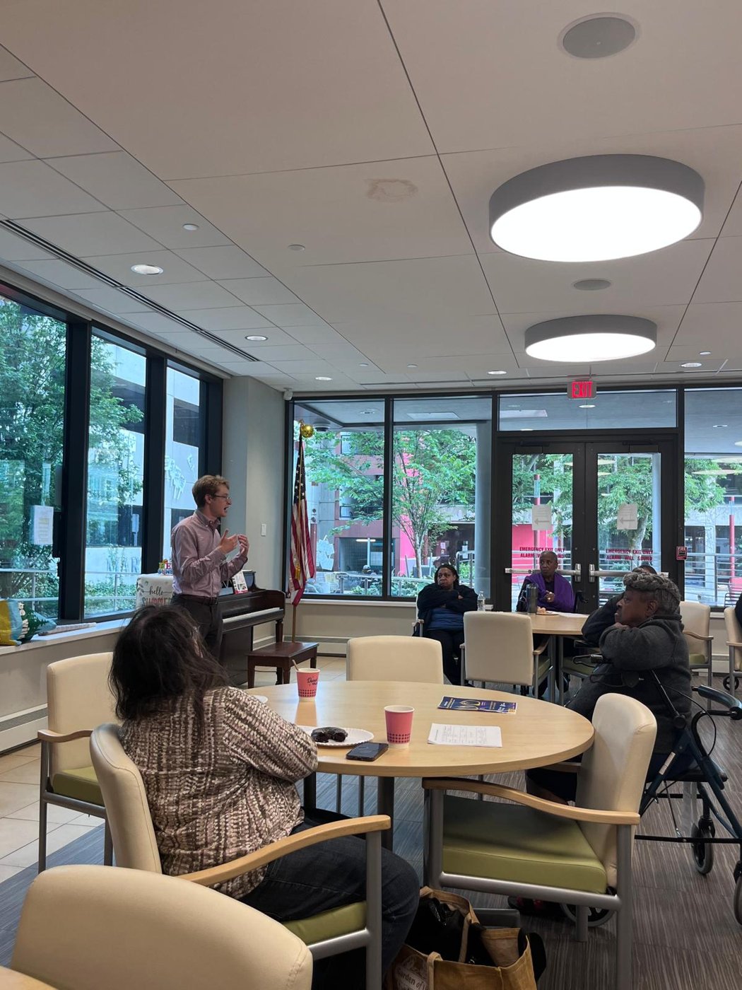 Neil speaking with residents at a senior center
