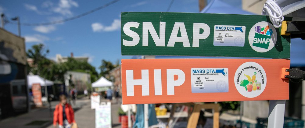 SNAP and HIP benefits sign at a farmers market